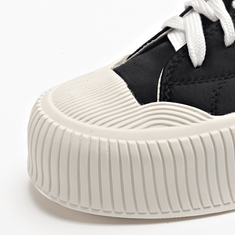 Women's casual lace-up sports shoes with thick flat rubber sole and silk upper, featuring a close-up of the round toe design.